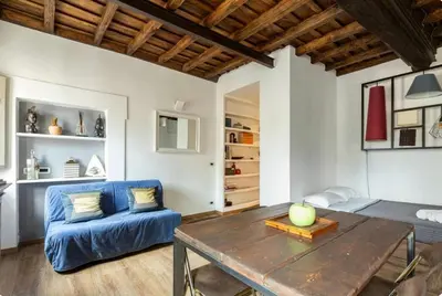 a living room with a blue couch and a table at Colosseo Luxury Suite in Rome