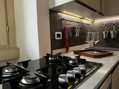 a kitchen with a stove top oven in a kitchen at Colosseo Luxury Suite in Rome