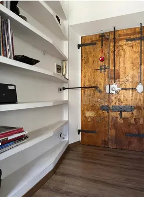 a room with a wooden door and shelves at Colosseo Luxury Suite in Rome