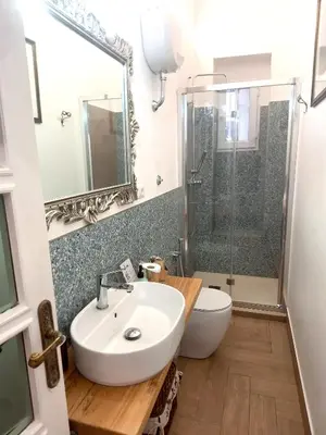 a bathroom with a sink and a toilet and a shower at Porta Labicana House -10 minutes from Termini Station in Rome
