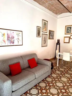 a living room with a gray couch and red pillows at Porta Labicana House -10 minutes from Termini Station in Rome