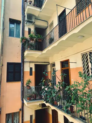 an apartment building with balconies and potted plants at Porta Labicana House -10 minutes from Termini Station in Rome