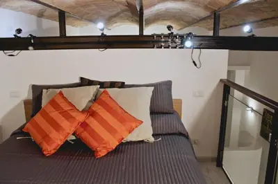 a bed with two pillows on it in a room at Opera House in Rome