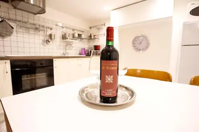a bottle of wine sitting on a counter in a kitchen at Opera House in Rome
