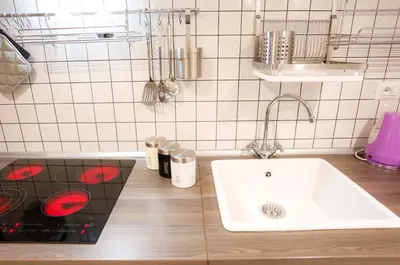 a kitchen with a white sink and a counter top at Opera House in Rome