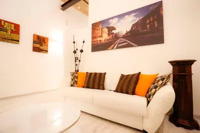 a living room with a white couch with pillows at Opera House in Rome