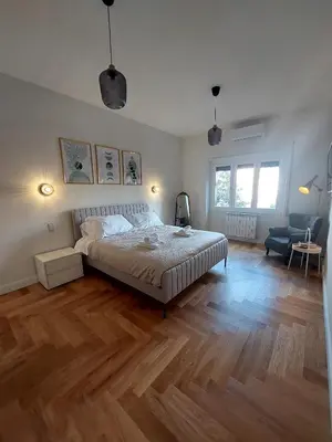 a bedroom with a bed and a wooden floor at casa gemelli vaticano roma in Rome