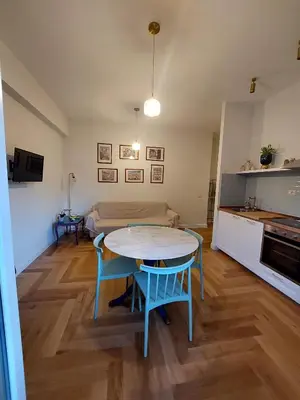 a kitchen and a living room with a table and chairs at casa gemelli vaticano roma in Rome