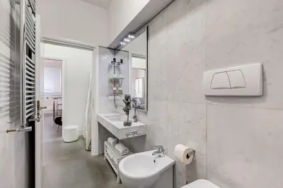 a white bathroom with a sink and a toilet at New Suite Barberini Area in Rome