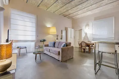 a living room with a couch and a table at New Suite Barberini Area in Rome