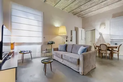 a living room with a couch and a table at New Suite Barberini Area in Rome