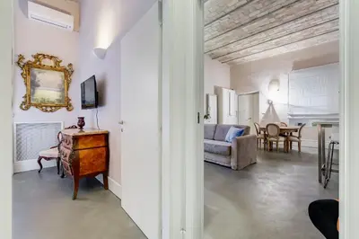a living room with a couch and a table at New Suite Barberini Area in Rome