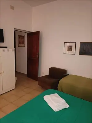a room with a bed and a couch and a table at Appartamento di Mila in Rome
