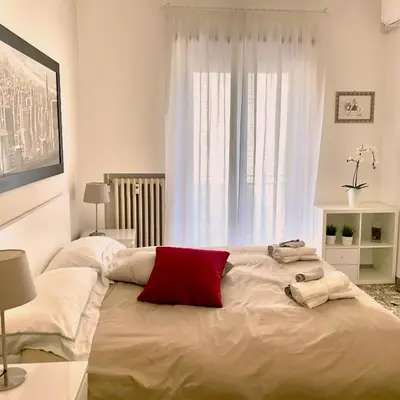 a bedroom with a large bed with two towels on it at Lazy Time Apartment in Rome