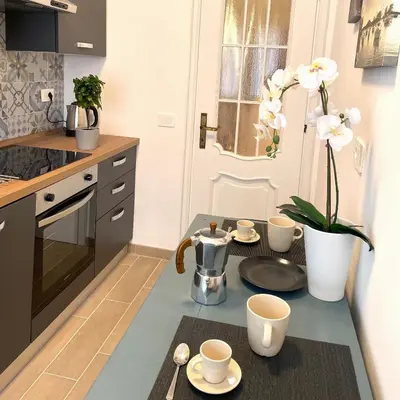 a kitchen with a table with cups and saucers on it at Lazy Time Apartment in Rome
