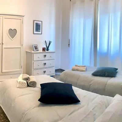 a bedroom with two beds with towels on them at Lazy Time Apartment in Rome