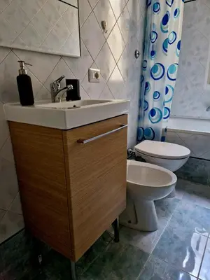 a bathroom with a sink and a toilet at Tiburtina Keys - Roma in Rome