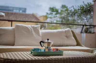 a coffee maker on a table on a patio at Da Cecilia alla Piramide Cestia in Rome