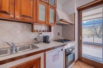 a kitchen with a sink and a stove at Da Cecilia alla Piramide Cestia in Rome