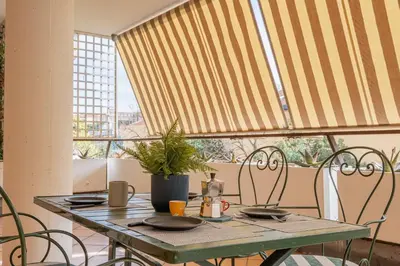 a table and chairs in a room with a window at Da Cecilia alla Piramide Cestia in Rome