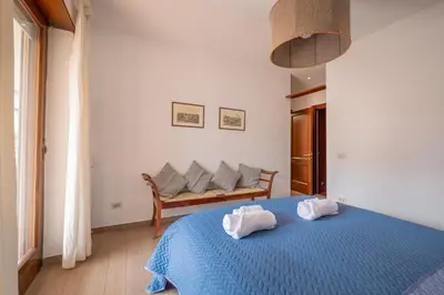 a bedroom with a blue bed with two towels at Da Cecilia alla Piramide Cestia in Rome