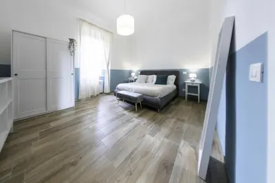 a living room with a bed and a couch at Colosseo Home San Giovanni in Rome