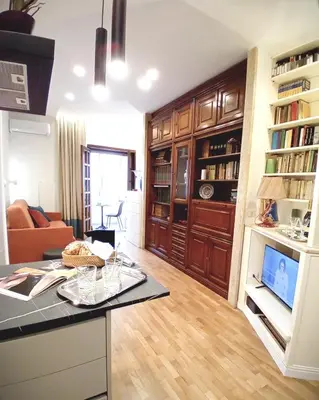 a living room with a kitchen and a living room with a couch at ad vatican luxury apartment in Rome