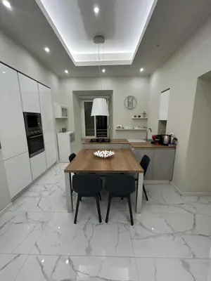 a large kitchen with a wooden table and chairs at Dielle Suite ROMA in Rome