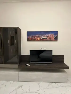 a entertainment center with a flat screen tv on a wall at Dielle Suite ROMA in Rome