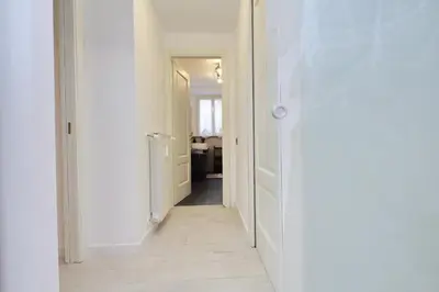 a hallway with white walls and a white hallway with a hallway at 4BNB - Ponte Milvio Apartment in Rome
