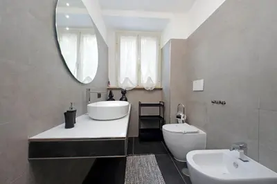a bathroom with a sink and a toilet and a mirror at 4BNB - Ponte Milvio Apartment in Rome