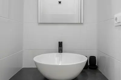 a white sink with a faucet in a bathroom at Studio Flat - Lungara 44A in Rome
