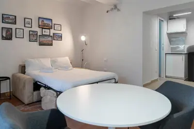 a room with a bed and a table and a couch at Studio Flat - Lungara 44A in Rome