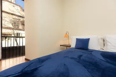 a bedroom with a blue bed and a balcony at Amazing Elegant Jewish Ghetto in Rome