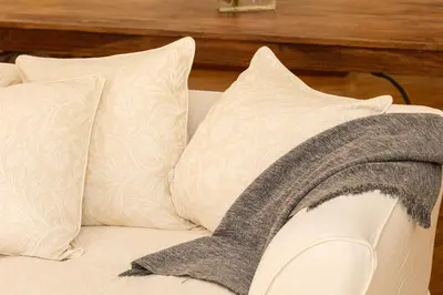 a blanket is sitting on a couch with pillows at Amazing Elegant Jewish Ghetto in Rome