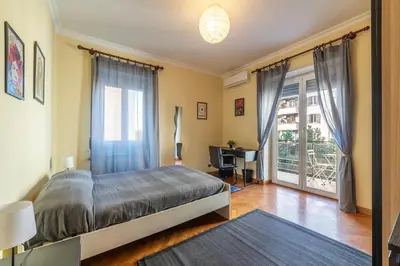 a bedroom with a bed and a desk and a window at San Paolo Apartment - Charme Holidays in Rome