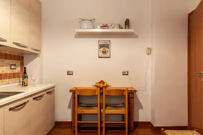 a kitchen with a wooden table with fruit on it at San Paolo Apartment - Charme Holidays in Rome