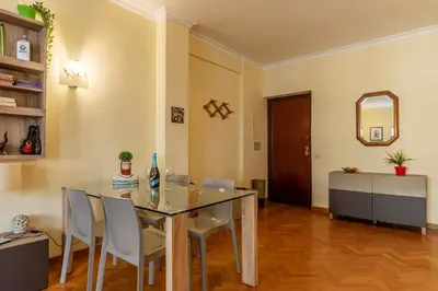 a dining room with a glass table and chairs at San Paolo Apartment - Charme Holidays in Rome