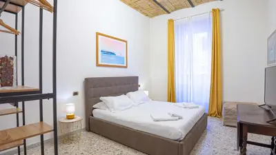 a bedroom with a bed and a television in it at Candia Delizioso Appartamento vicino al Vaticano in Rome