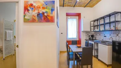 a kitchen and dining room with a table and chairs at Candia Delizioso Appartamento vicino al Vaticano in Rome