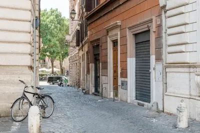 a bike parked on a street next to a building at Beige luxury apartment Rome in Rome