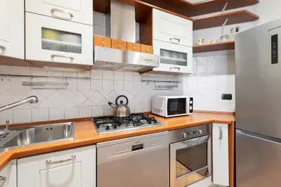 a kitchen with white appliances and a stove top oven at Beige luxury apartment Rome in Rome