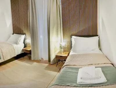 a bedroom with two beds and two night stands at Minerva Boutique Residence in Rome