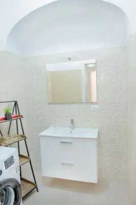 a bathroom with a white sink and a mirror at Minerva Boutique Residence in Rome