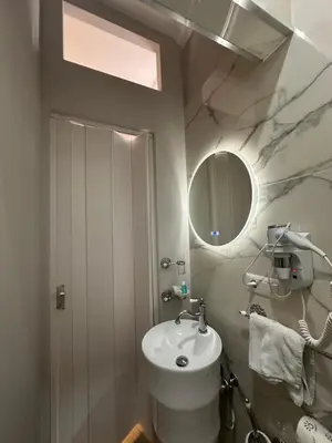 a bathroom with a shower with a shower head at Angelus Vaticanus Room in Rome