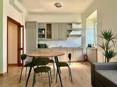 a kitchen with a table and chairs in a room at MuMo Home Pigneto in Rome