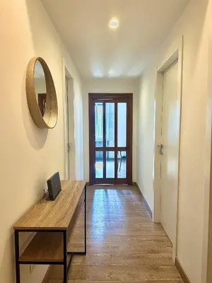 a hallway with a table and a mirror on the wall at MuMo Home Pigneto in Rome