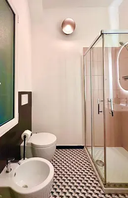a bathroom with a toilet and a sink and a shower at MuMo Home Pigneto in Rome