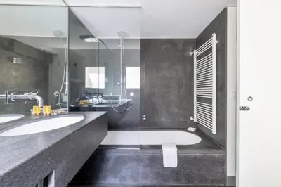 a bathroom with two sinks and a shower at Farnesi Terrace Penthouse in Rome
