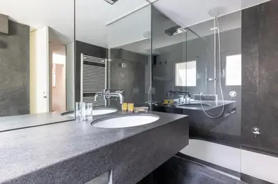 a bathroom with a sink and a mirror at Farnesi Terrace Penthouse in Rome